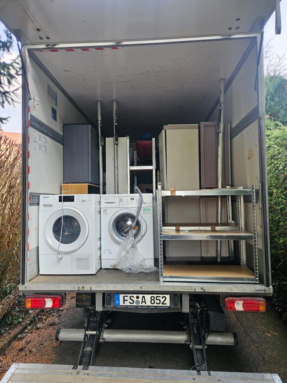Beladener Transporter mit Waschmaschinen und Möbeln